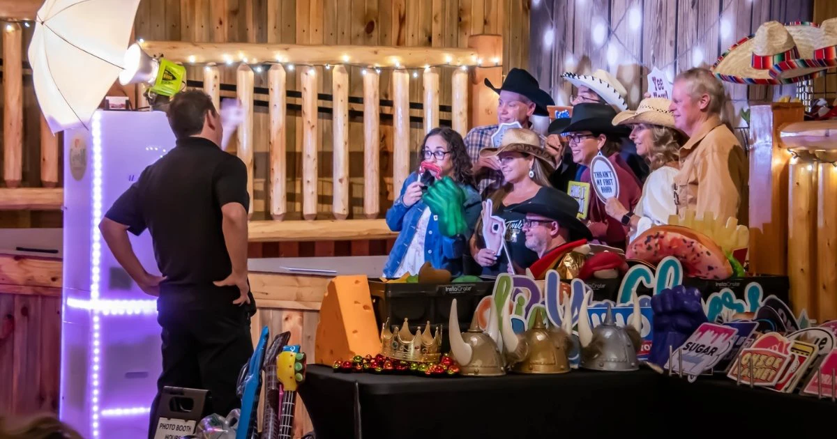 Photo Booth hosted during a corporate gala in Loveland Co. Guests posing for photos with an attendant helping to direct them for the perfect photo booth photo.