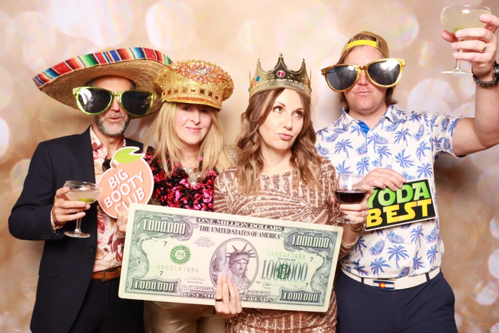 Premium Photo Booth Backdrop with Guests Posing with Props | CaptureME Photo Booth Rental Company in Windsor, CO | Weddings and Corporate Events in Northern Colorado
