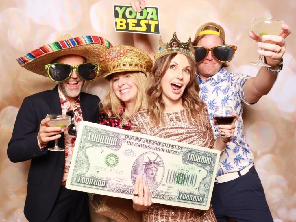 Premium Photo Booth Backdrop with Guests Posing with Props | CaptureME Photo Booth Rental Company in Windsor, CO | Weddings and Corporate Events in Northern Colorado