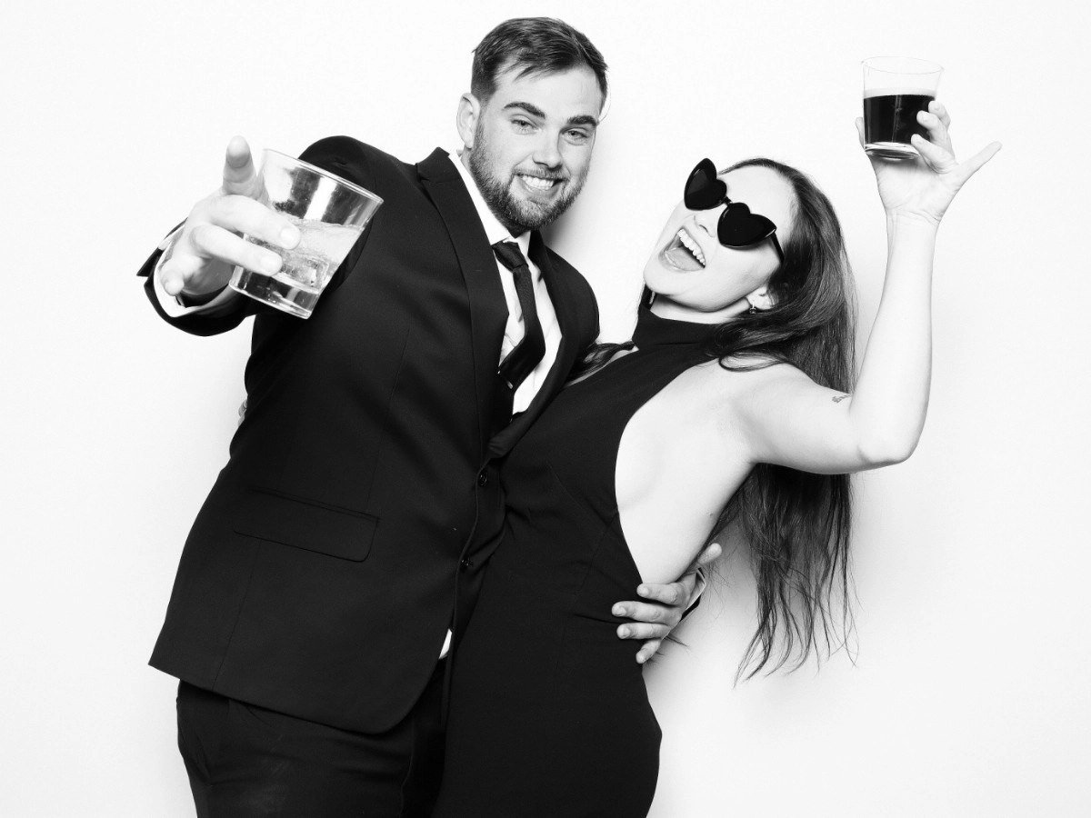 Guests posing with drinks in hand | Black and White Glam Booth filter | Windsor, CO