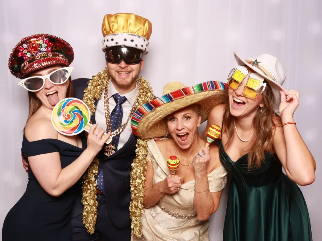 Guests posing with props and backdrop | CaptureME Photo Booth Rental Company in Windsor, CO | Weddings and Corporate Events in Northern Colorado