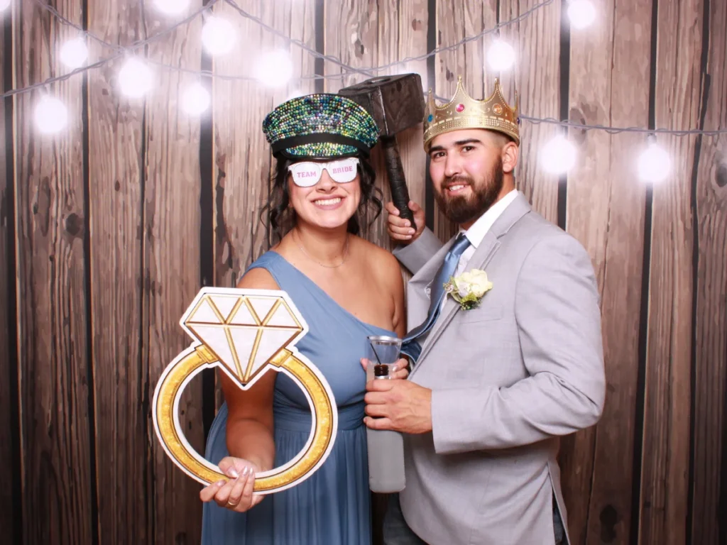 Guests posing with props and backdrop | CaptureME Photo Booth Rental Company in Windsor, CO | Weddings and Corporate Events in Northern Colorado