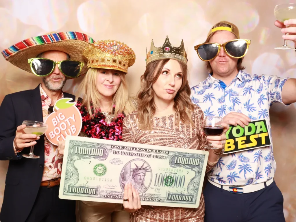 Guests posing with props and backdrop | CaptureME Photo Booth Rental Company in Windsor, CO | Weddings and Corporate Events in Northern Colorado